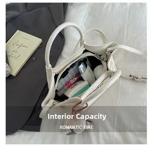 Detail view showing large interior capacity of white pleated tote bag for cosmetics