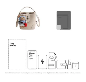Detail view of cream lychee texture bucket bag showing large storage capacity and bear charm