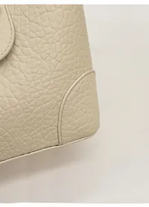 Macro detail of high-quality lychee grain leather texture and precise corner stitching