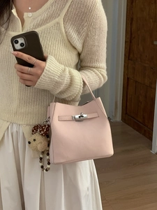 Elegant pale pink leather bucket bag with silver lock and cute teddy bear charm