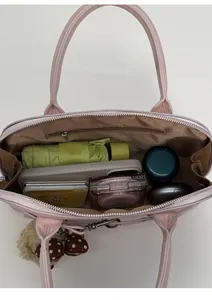 Internal view of pink shell bag showing large capacity and smooth zipper storage