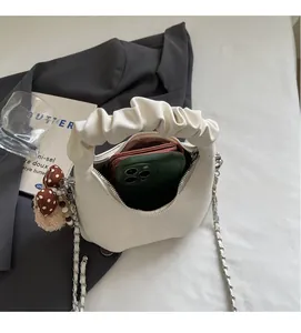 Internal view of beige ruched cloud bag showing space for a phone and pink wallet