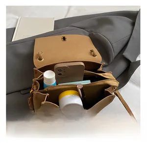 Detail view of the spacious multi-compartment interior for the vintage brown crossbody bag