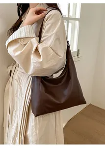Deep brown retro hobo bag worn by a model in a minimalist setting for casual daily use