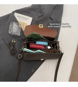 Detail view of large interior space for phone and wallets in brown vintage bag