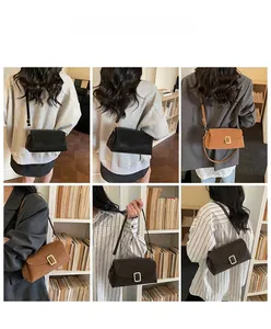 Detail showing the retro small square crossbody bag in black and caramel matte textures