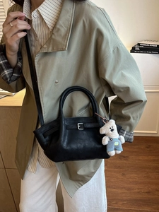 Chic black matte leather bucket bag with silver buckle and cute white bear charm