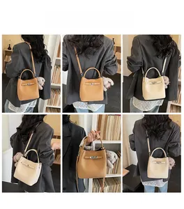 Modello con borsa a secchiello in pelle martellata con chiusura metallica a tracolla