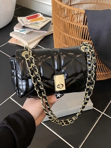Chic black quilted crossbody bag with gold chain strap and twist-lock closure