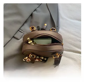 Top view of brown leather bag interior showing perfume and accessories capacity