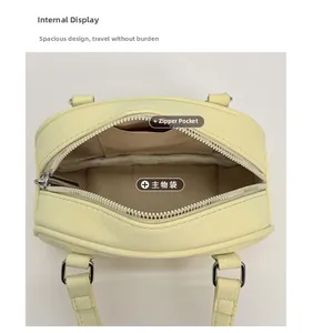 Interior view of small yellow handbag showing main compartment and zippered pocket