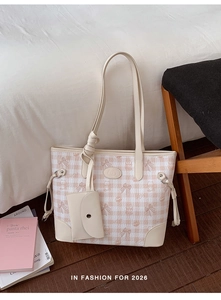 Detail of pink plaid tote bag featuring embossed bear pattern and mini envelope pouch