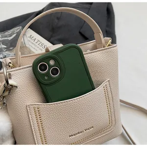 Détail du sac seau en cuir grainé avec poche avant et espace de rangement