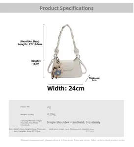 Detail view of cream white PU crossbody bag with woven handle and cute bear pendant
