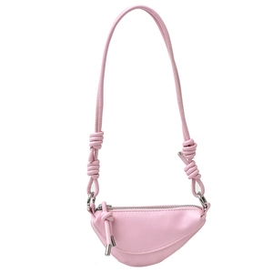 Pink saddle crossbody bag with minimalist asymmetric half-moon design and knotted strap