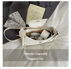 Internal capacity of the cream square crossbody bag showing phone and cosmetics