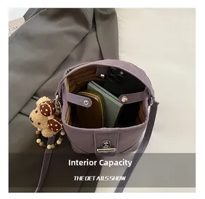 Detail showing internal capacity of the lavender bucket bag with phone and essentials