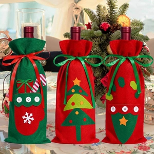 Three festive Christmas wine bottle covers with ribbons and embroidery decorations