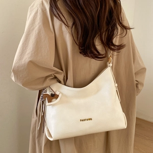 Detail of off-white Hobo shoulder bag with gold logo and brown horse pendant