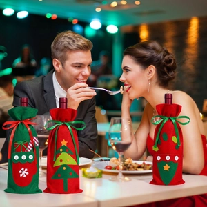 Detail of Christmas wine bottle covers with felt embroidery of tree and candy canes