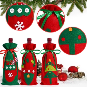 Close-up of felt Christmas wine bottle gift bags with snowflakes and star buttons