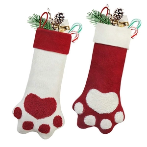 Detailed knit texture of festive dog paw Christmas stockings with fluffy plush accents