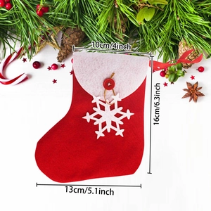 Classic red Christmas stocking with white trim and snowflake ornament on wooden background