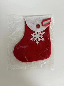 Detail of red Christmas stocking gift bag with white snowflake applique and hanging loop