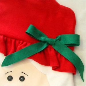 Macro detail of Christmas felt chair cover with green ribbon bow and button eyes