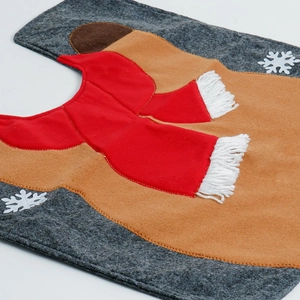 Close-up of reindeer pattern and white snowflakes on the Christmas U-shaped toilet rug