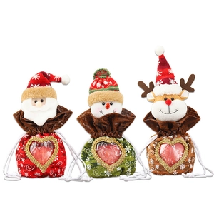 Three Christmas drawstring gift bags with Santa, Snowman, and Reindeer heart window designs