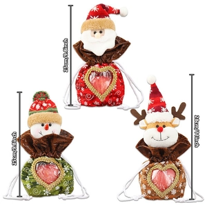 Three Christmas drawstring bags with heart-shaped windows and festive holiday designs