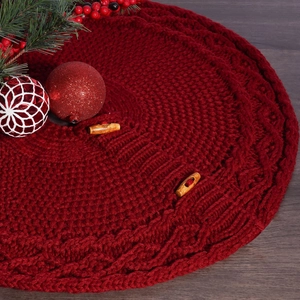 Close-up of burgundy cable knit Christmas tree skirt with rustic wooden toggle buttons