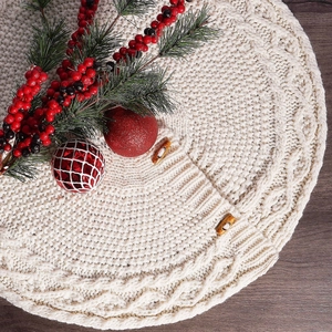 Close-up of cream cable knit Christmas tree skirt with wooden toggle buttons