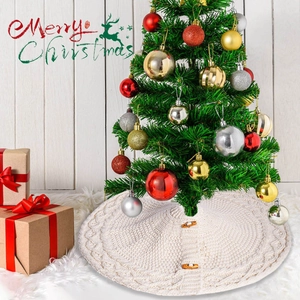 Detail of cream cable knit Christmas tree skirt with wooden buttons on plush white rug