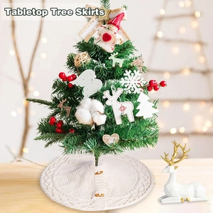 Close-up of cream knit mini Christmas tree skirt with wood buttons and cable textures