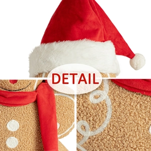 Detail shot of plush gingerbread man toy with festive red hat and soft teddy fleece texture