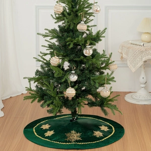 Détail du tapis de sapin de Noël en velours vert foncé avec broderies flocons dorés