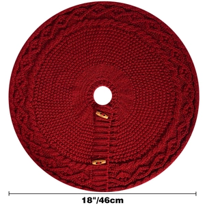 Macro detail of red knitted Christmas tree skirt with wooden buttons and cable knit pattern