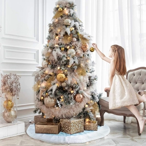 Elegant Christmas tree decoration set with gold baubles, white feathers and warm light strings