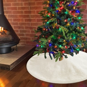 Close-up of fluffy white faux fur Christmas tree skirt on dark wood floor decoration
