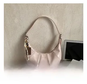 Detail of pink hobo bag featuring LOVE & DESIRE text and vertical stitched texture