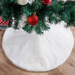 Macro shot of snow-white faux fur Christmas tree skirt texture on wood floor