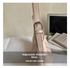 Detail showing adjustable shoulder strap with silver buckle on a pink tote bag