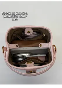 Internal capacity of the pink leather handbag showing daily items and storage pockets