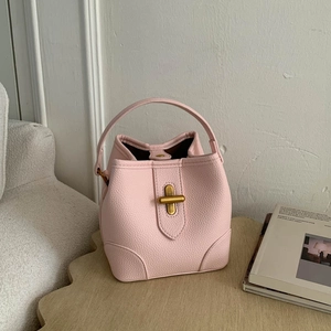 Pink lychee textured leather bucket bag with gold metal clasp for daily fashion