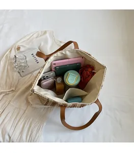 Interior view of large straw tote bag showing spacious lining and daily essentials
