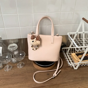 Pink lychee grain tote bag with cute teddy bear charm and adjustable shoulder strap