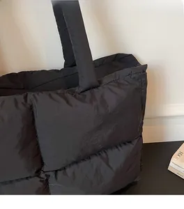 Close-up of the black quilted puffer tote bag made of lightweight soft fabric