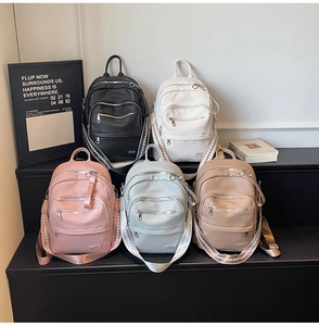 Five assorted colors of litchi texture PU leather backpacks with triple front zip pockets